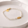 Pulseira pérolas com flor de lótus em aço